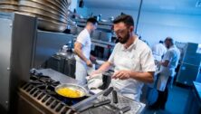 (left) Nicholas Elmi, chef/owner, and (center) Michael Millon, executive chef, work in the kitchen at Lark in Bala Cynwyd.