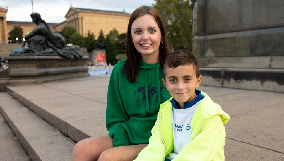 Older girl cousin, left and younger boy cousin, right sitting on steps