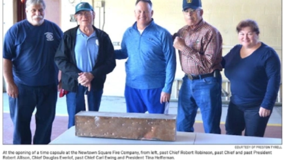Screenshot of newspaper clipping of firefighters with time capsule
