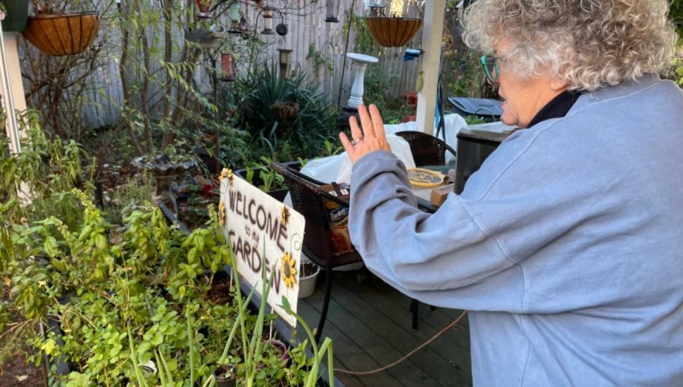 Darby resident Paula Brown with her planter box garden she uses to battle rising prices