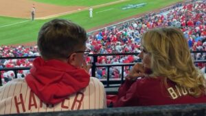 Luke Theodosiades and first lady Jill Biden watch the World Series