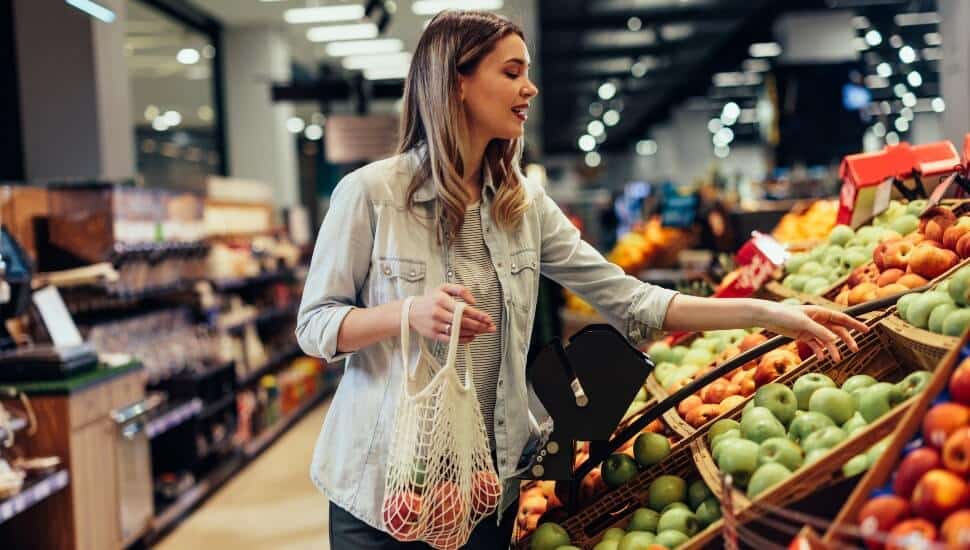 Woman selecting produce at a grocery store