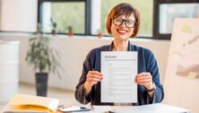 fifty plus woman holding resume document sitting a office