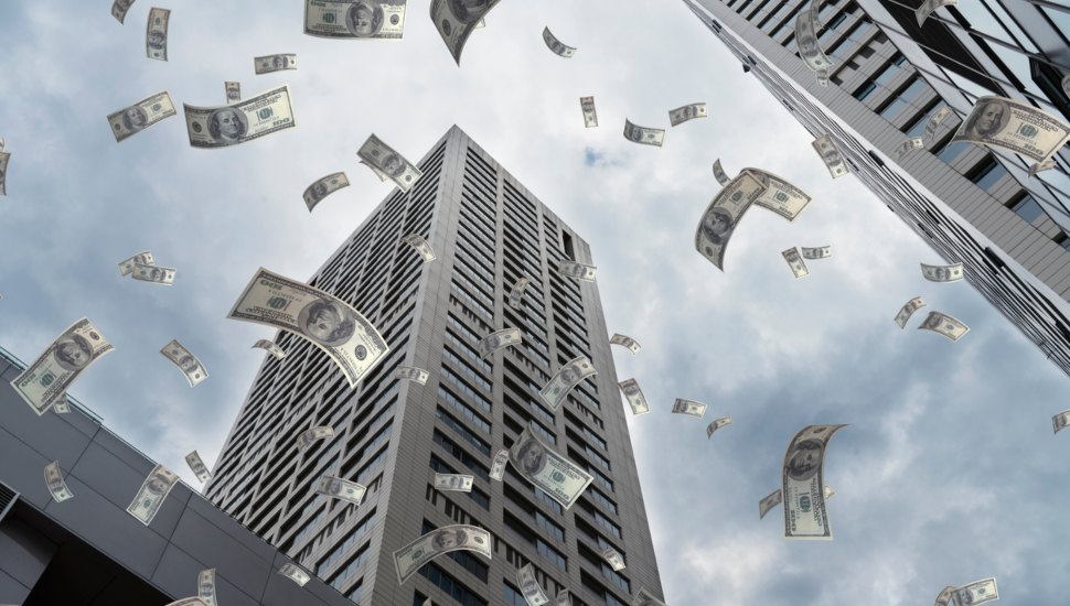 Money falling from the sky in a city