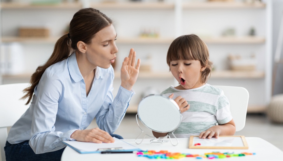 A teacher works with a child