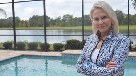 Nancy Perpall stands by a pool