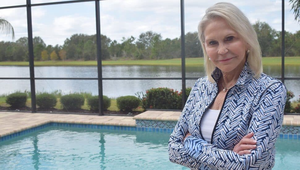 Nancy Perpall stands by a pool