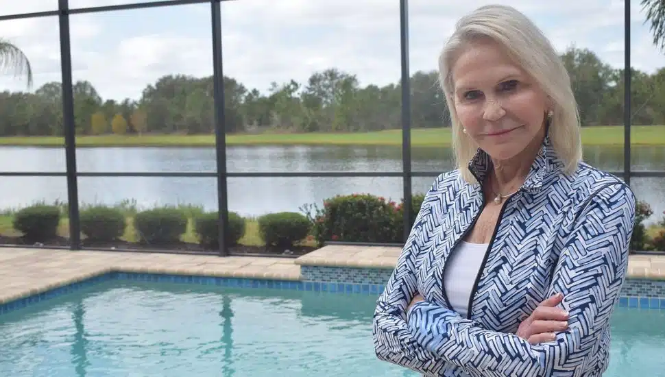 Nancy Perpall stands by a pool