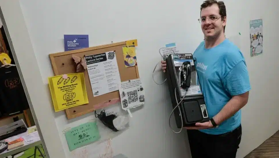 Mike Dank shows where the first PhilTel pay phone will go