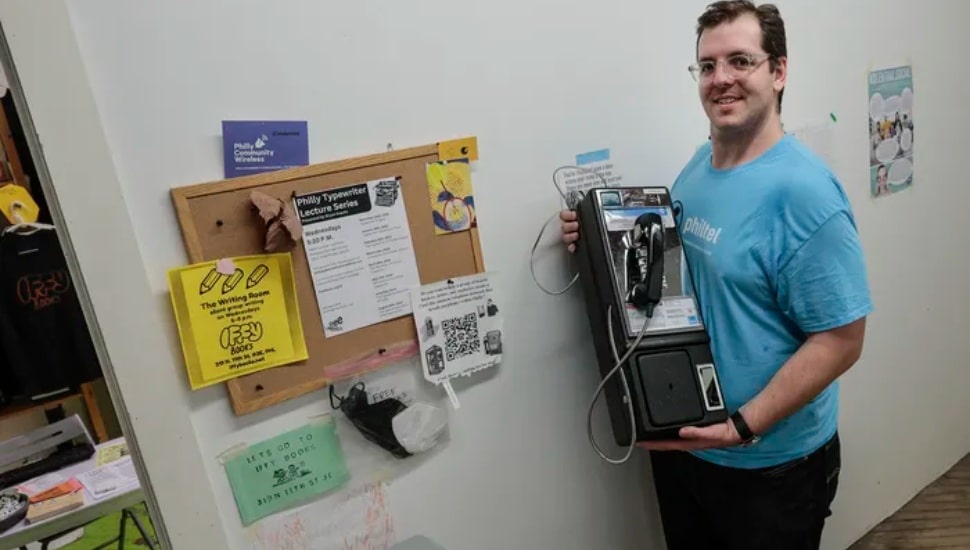 Mike Dank shows where the first PhilTel pay phone will go