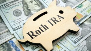 Roth IRA on a backdrop of $100 dollar bills