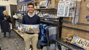 Michael Tufankjian in the Villanova bookstore with one of his pillow print designs