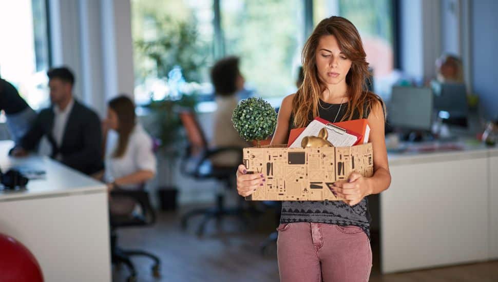 young woman got fired and moving out of the office, laid-off