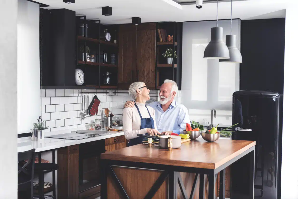 A senior couple cooking vegetables in a kitchen