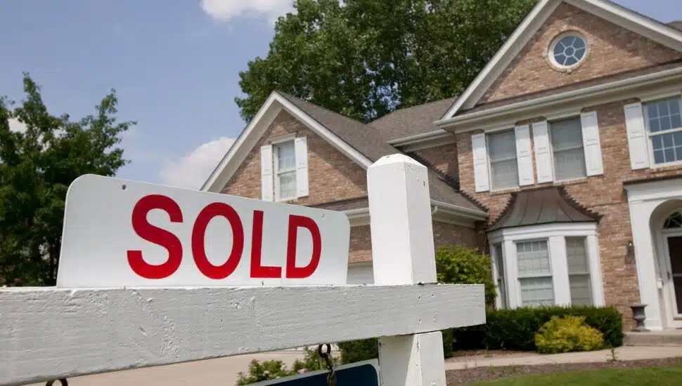 A sold sign outside of a single family home