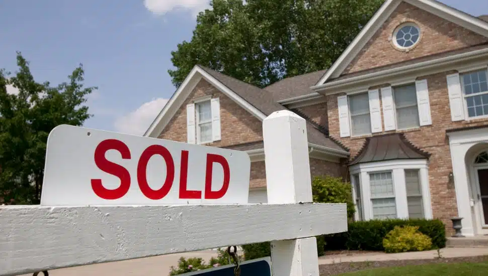 A sold sign outside of a single family home