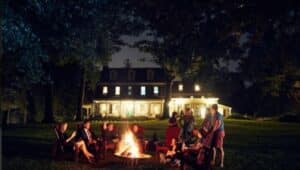 A group enjoys a night by the fire at the Inn at Grace Winery