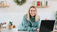 Business woman working at home on laptop during Christmas and New Year