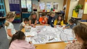Students from kindergarten through fifth grade work together on a project