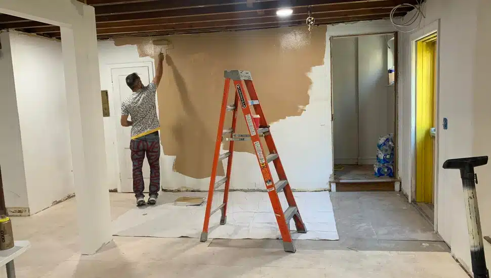 A man paints the walls of the Breaking Bread Community shelter in Upper Darby prior to its opening in December 2022