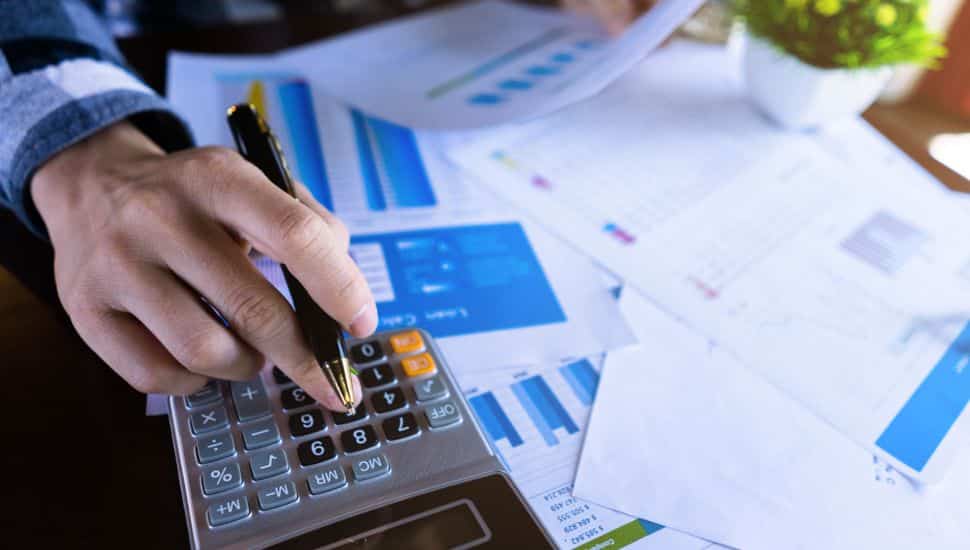 accountant with papers using calculator