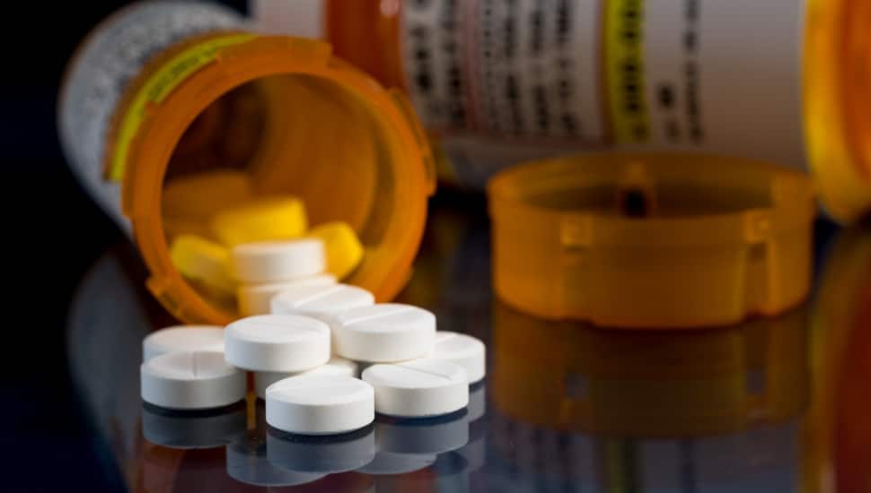 A bottle of spilled opioid tablets