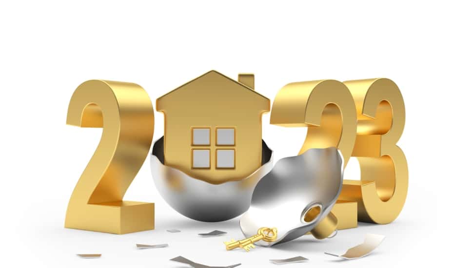 Image of a golden house emerging from a Christmas ball with a golden 2023 behind it