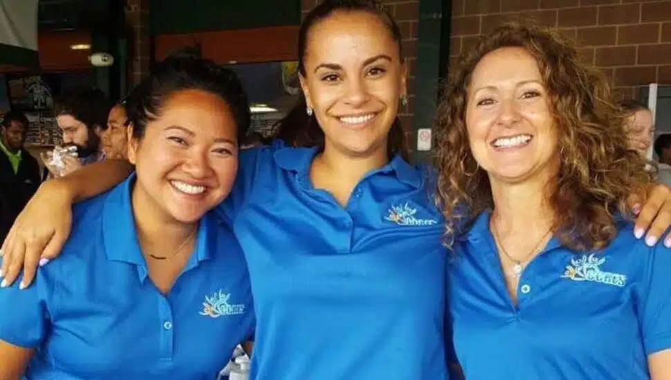 Three smiling women wearing CCRES shirts