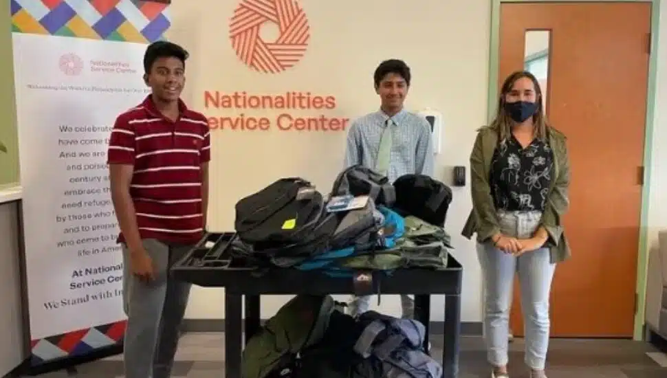 Advaith Kollipara, left, and Daniel Adibi, right, with donated school supplies.