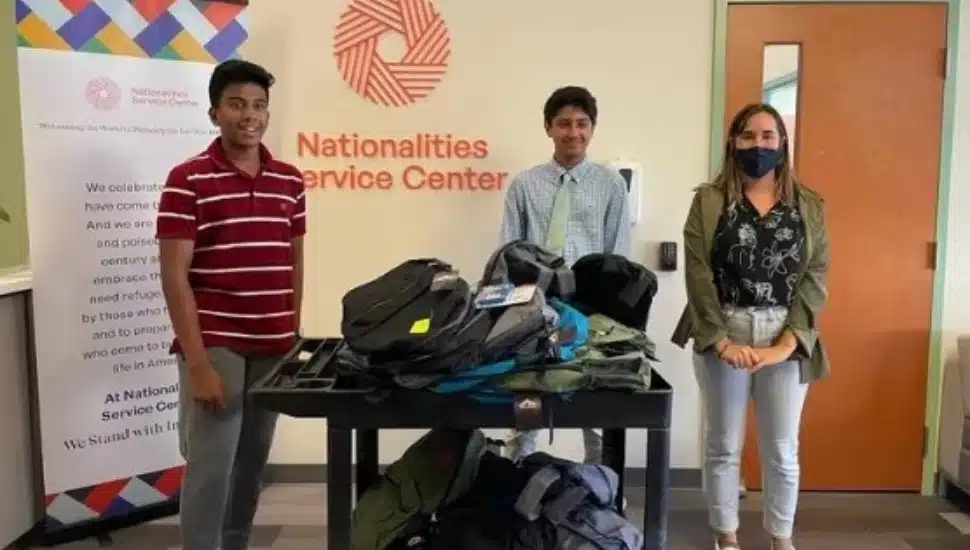 Advaith Kollipara, left, and Daniel Adibi, right, with donated school supplies.