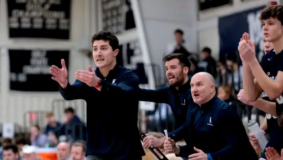 Taylor Wright coaching from the sidelines during a basketball game