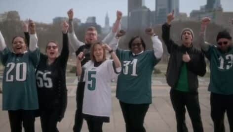 People dressed in Philadelphia Eagles gear appearing in a Super Bowl ad for Wawa