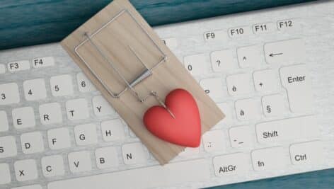 Image of a heart in a trap on top of a computer keyboard