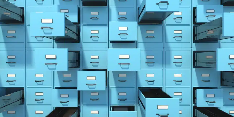 A room full of filing cabinets some open, some closed