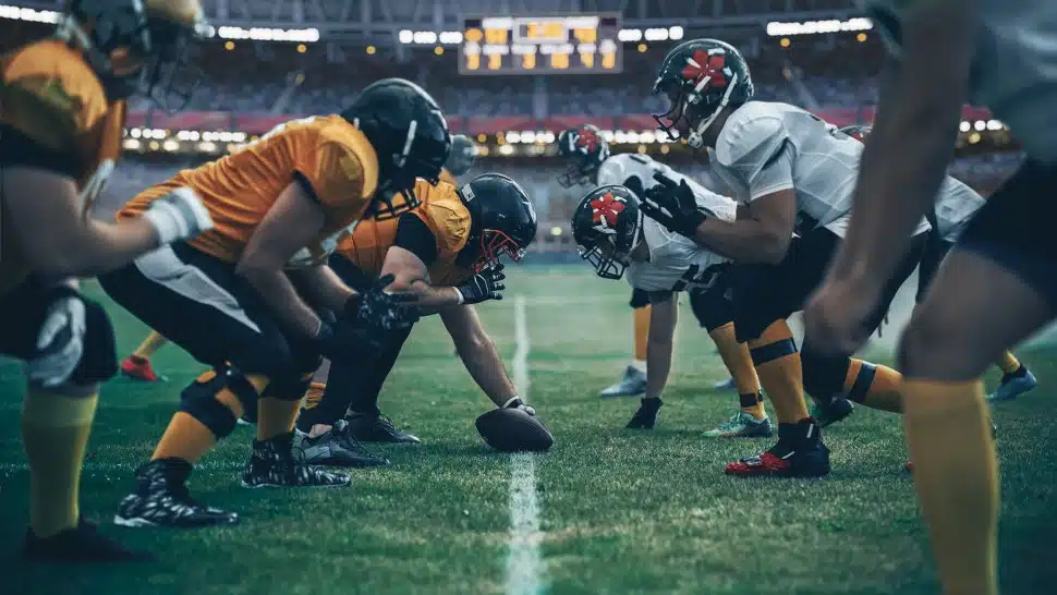Football players face off for a play
