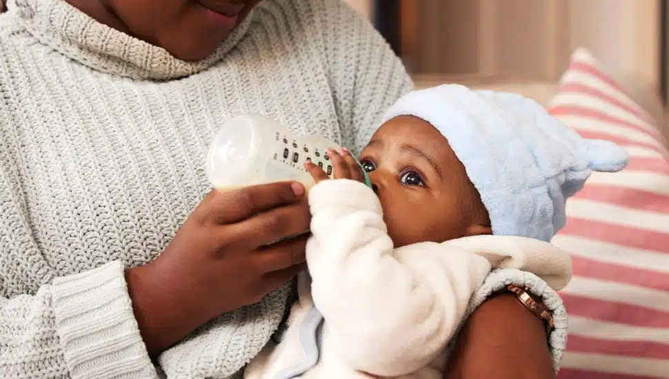 A new Black mom holding her baby