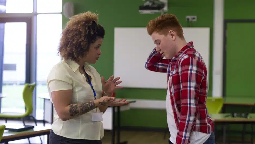 A woman counselor talking with a male student