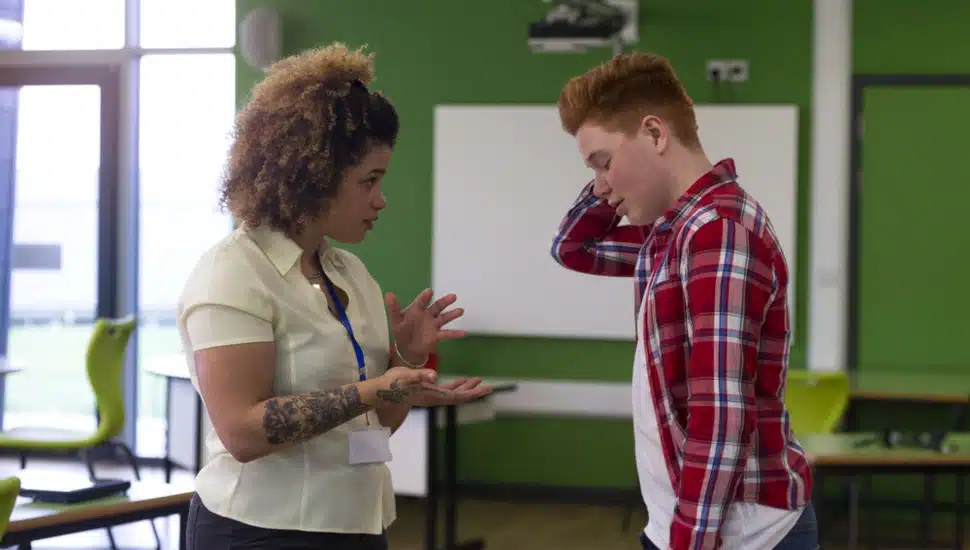 A woman counselor talking with a male student
