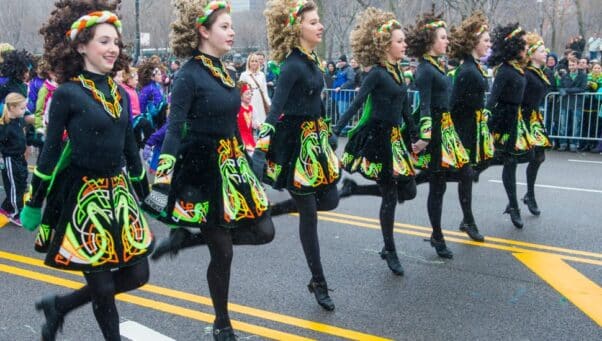 Irish dancers in a row along a Chicgo St. Patrick's Day parade route