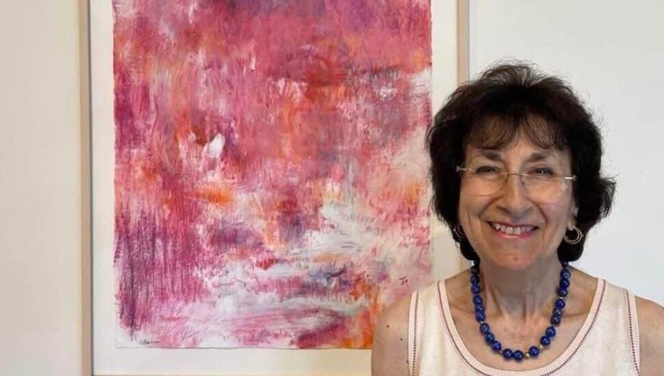 Artist Sandra Benhaim next to one of her paintings
