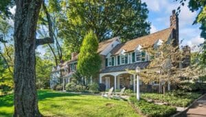 A classic colonial home in Haverford with a front yard and tree