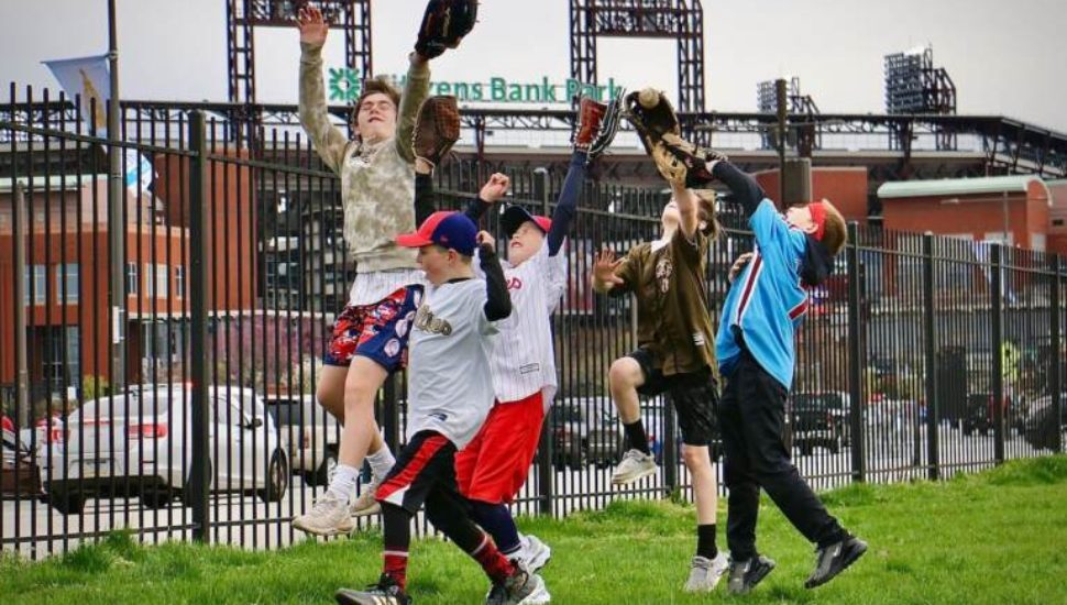 Players form the Aston Middletown Little League play catch outside Citizens Bank Park at the Phillies home opener