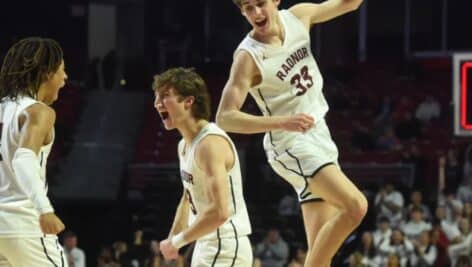 Radnor Raptor players during a game (from left) Charlie Thornton, Cooper Mueller, and Jackson Hicke celebrate Mueller's 3-point basket