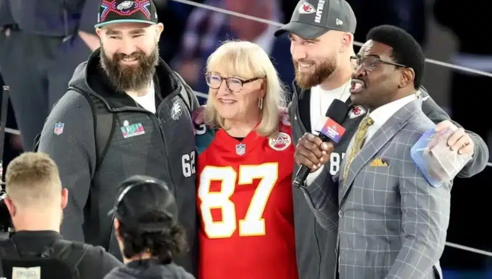 Philadelphia Eagles center Jason Kelce (left) stands with his mom, Donna, and Kansas City Chiefs tight end Travis Kelce (second from right) at Super Bowl LVII