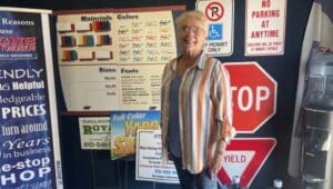 Signs for Tomorrow Owner Joyce Carpenter surrounded by signs at her Morton business