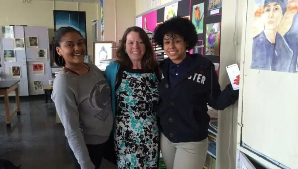 Mary Pat Ford stands with two students at Pennsauken High School in Pennsauken Township