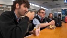 Michael Schuller (middle) having lunch with two peer mentoring students at Archbishop Carroll High School