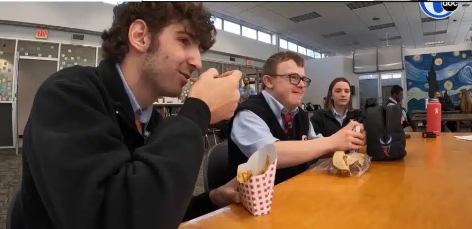 Michael Schuller (middle) having lunch with two peer mentoring students at Archbishop Carroll High School