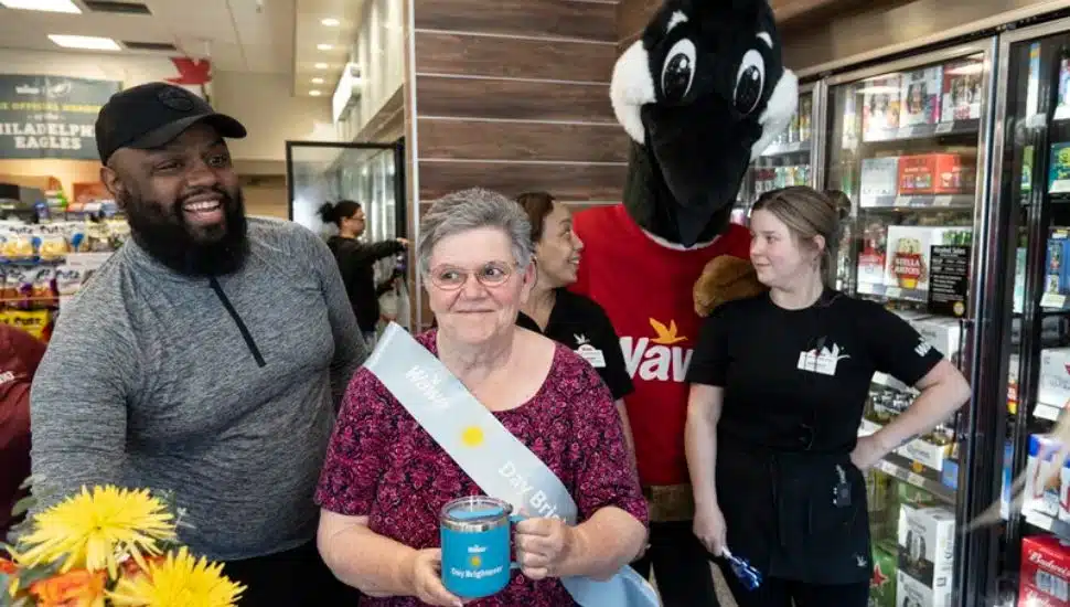 Wawa assistant general manager Jacob Blue, left, and the staff at the Boothwyn Wawa congratulate Cherylann Siple