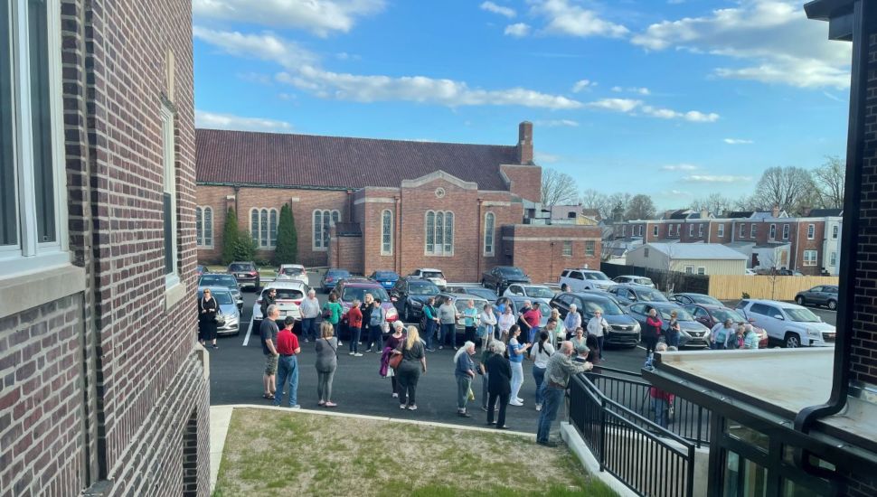 Alumni and friends of the former St. Joseph Parish School wait outside for the tour to start of the transformed building
